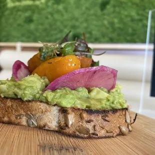avocado and radishes on a piece of bread