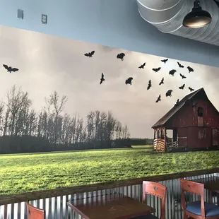 a barn and a flock of birds