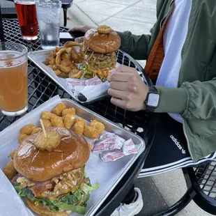 Signature Burger with tater tots (to the left) &amp; Meat Sweats with fries (to the right). Ice cold sours to sip on.