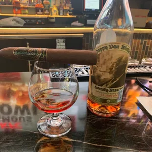 a cigar and a glass of wine