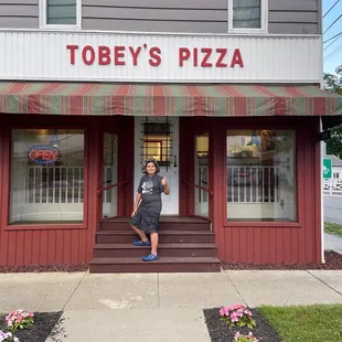 a woman standing in front of a restaurant