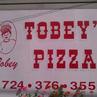 a sign for tobey's pizza