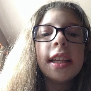 a girl with glasses and a tie