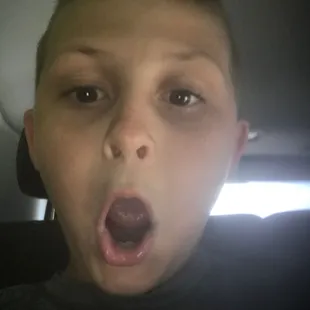 a boy sticking out his tongue