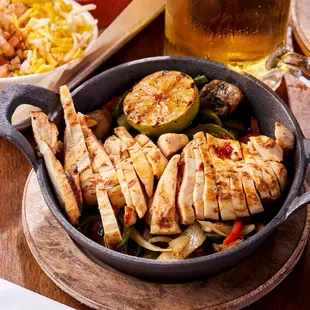 a pan of chicken and vegetables