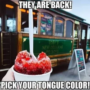 a hand holding a cup of ice cream