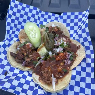 two tacos on a checkered paper