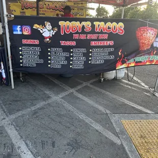 a taco stand with a menu