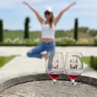 two wine glasses on a barrel