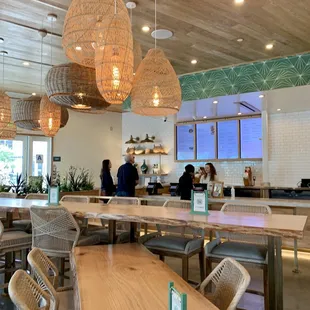 a dining area with wicker chairs and tables