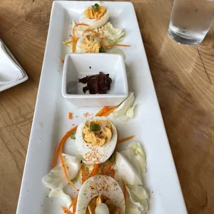 a long rectangular plate with a variety of food items on it