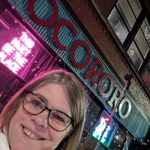 a woman in front of a restaurant