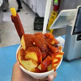 a hand holding a bowl of ice cream