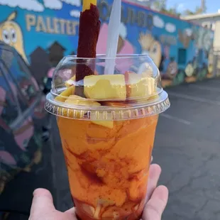 a hand holding a cup of ice cream