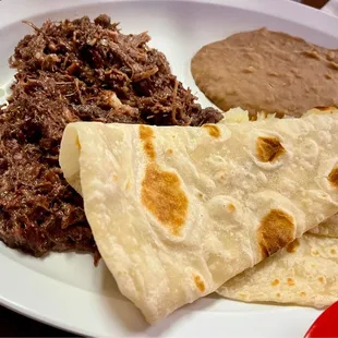 Barbacoa with massive home made flour tortillas beans and hash browns