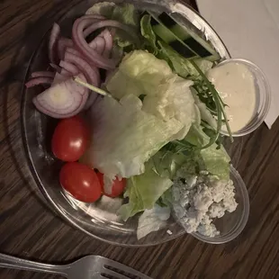Side salad with blue cheese dressing and crumbles