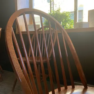 a wooden chair in front of a window