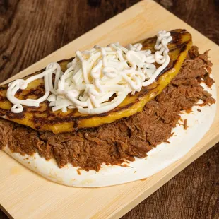  close up of a taco on a wooden board