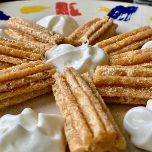 Churros with honey and whipped cream