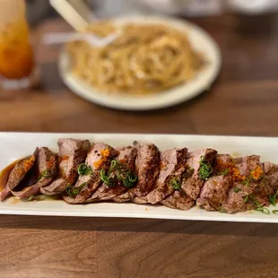 a plate of meat and noodles on a table