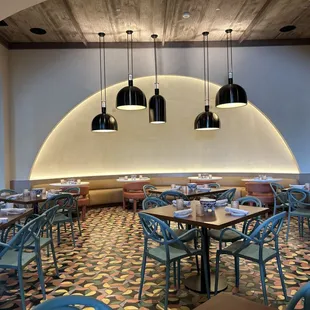 a dining area with tables and chairs