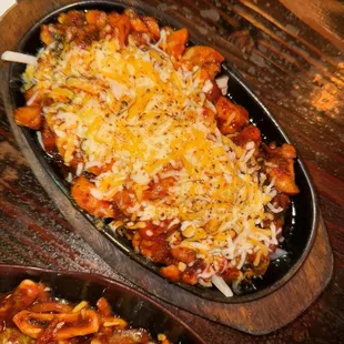 a dish of pasta with cheese on top