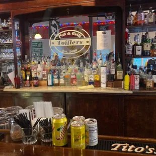 a bar with a variety of drinks