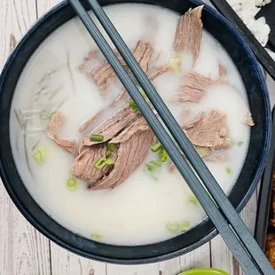 a bowl of soup and chopsticks