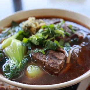 a bowl of beef and broccoli soup
