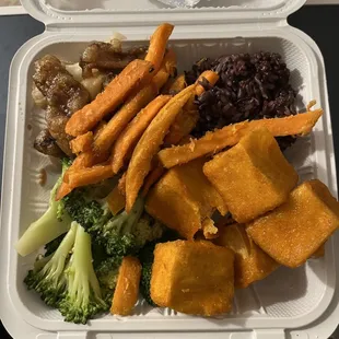 a variety of foods in a styrofoam container
