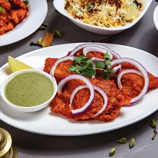 a plate of indian food and a side dish