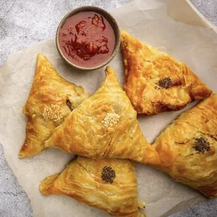 a plate of pastries and a bowl of ketchup