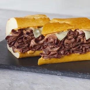 a roast beef sandwich cut in half