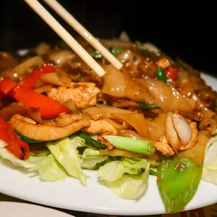 a plate of food with chopsticks