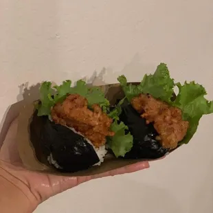 a hand holding a sandwich