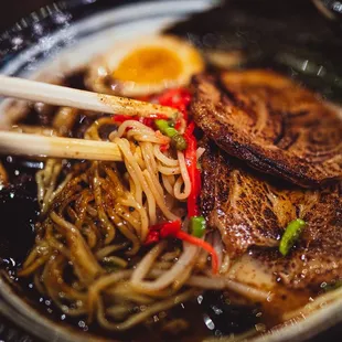 a bowl of ramen and chopsticks