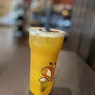 Large Mango Green Tea with mango popping boba.