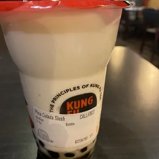 a plastic cup with a spoon sticking out of it