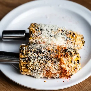 a white plate with a piece of food on it