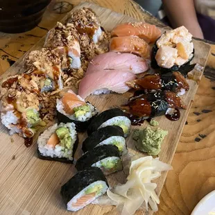 a variety of sushi on a cutting board