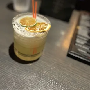 a drink with a slice of lemon on the rim