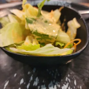 a bowl of salad on a table