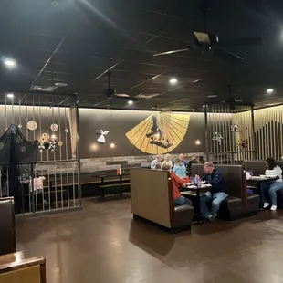 people sitting at tables in a restaurant