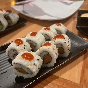 sushi rolls on a black plate