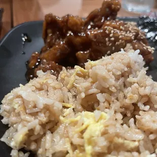 a plate of rice, meat and eggs