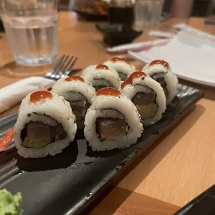 sushi rolls on a black plate