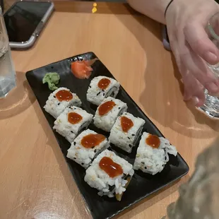 a plate of sushi rolls on a table