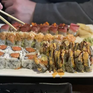 a plate of sushi and chopsticks