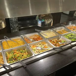 a variety of food in a buffet