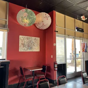 tables and umbrellas hanging from the ceiling